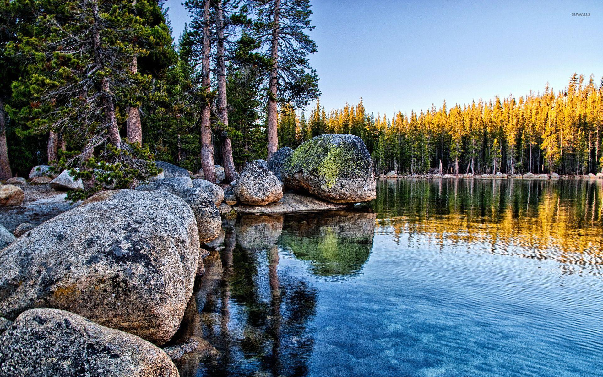 Mossy rocks pilling on the lake shore in Yosemite National Park