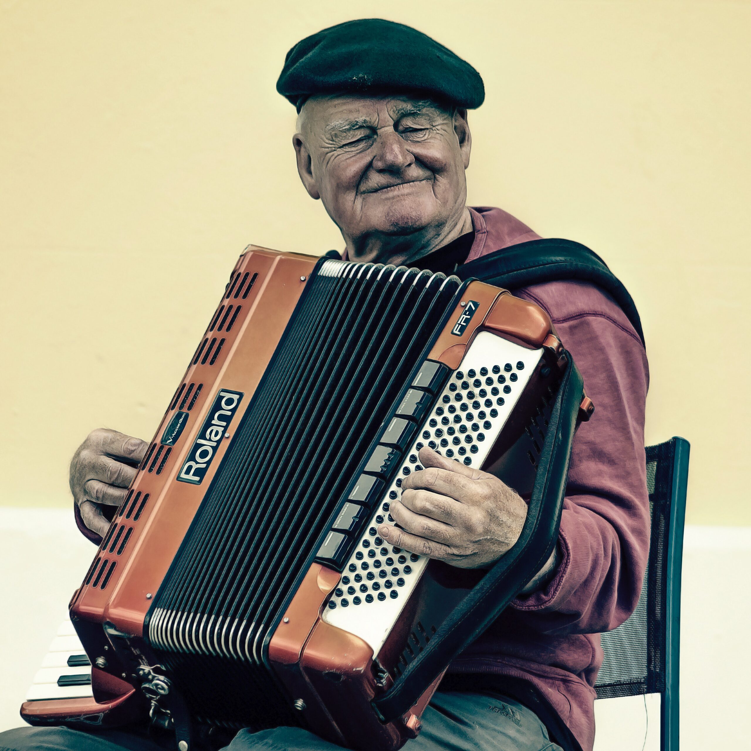 Man Sitting Playing Accordion · Free Stock Photo