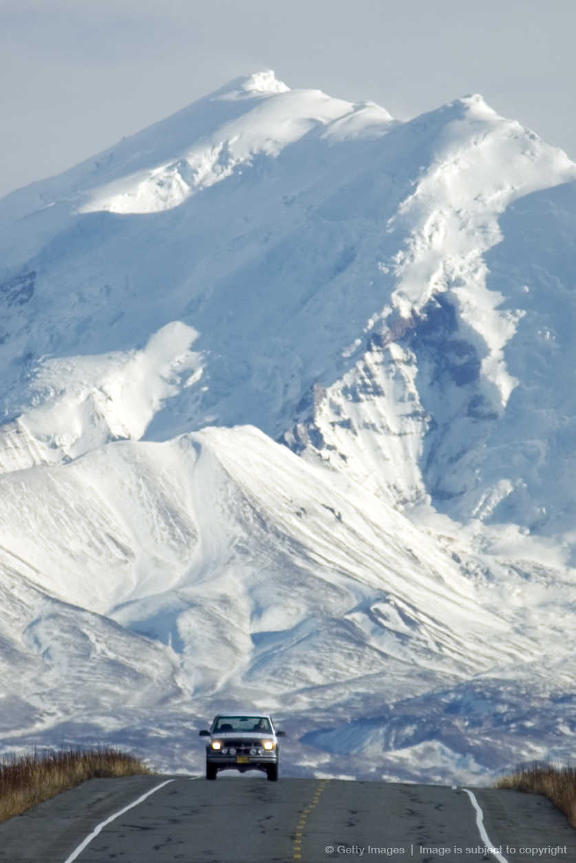 Car on highway with Mount Drum in background, Wrangell