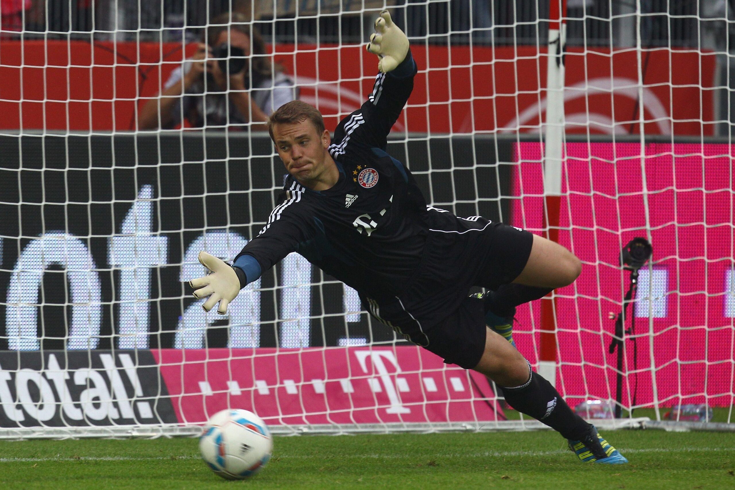 The football player of Bayern Manuel Neuer catching a ball