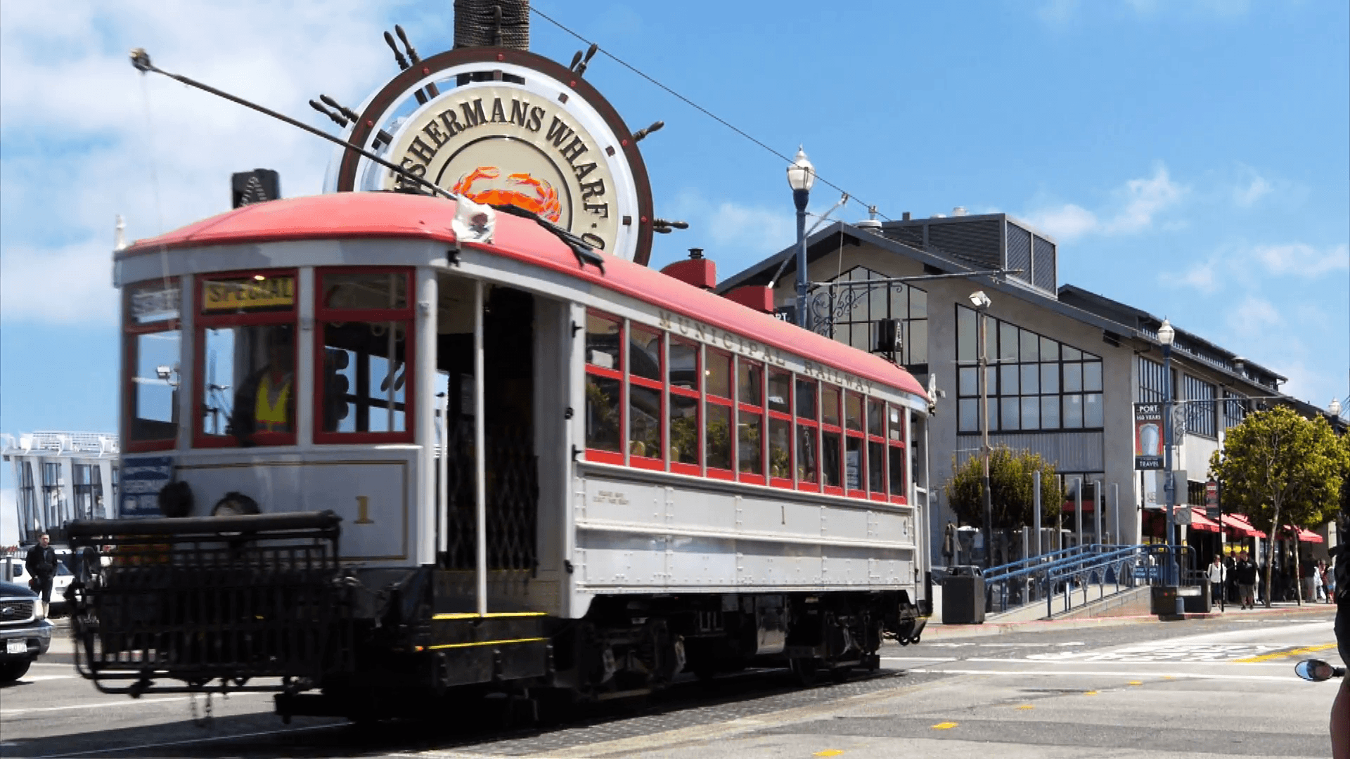 a cable car travels past the famous fisherman’s wharf district of