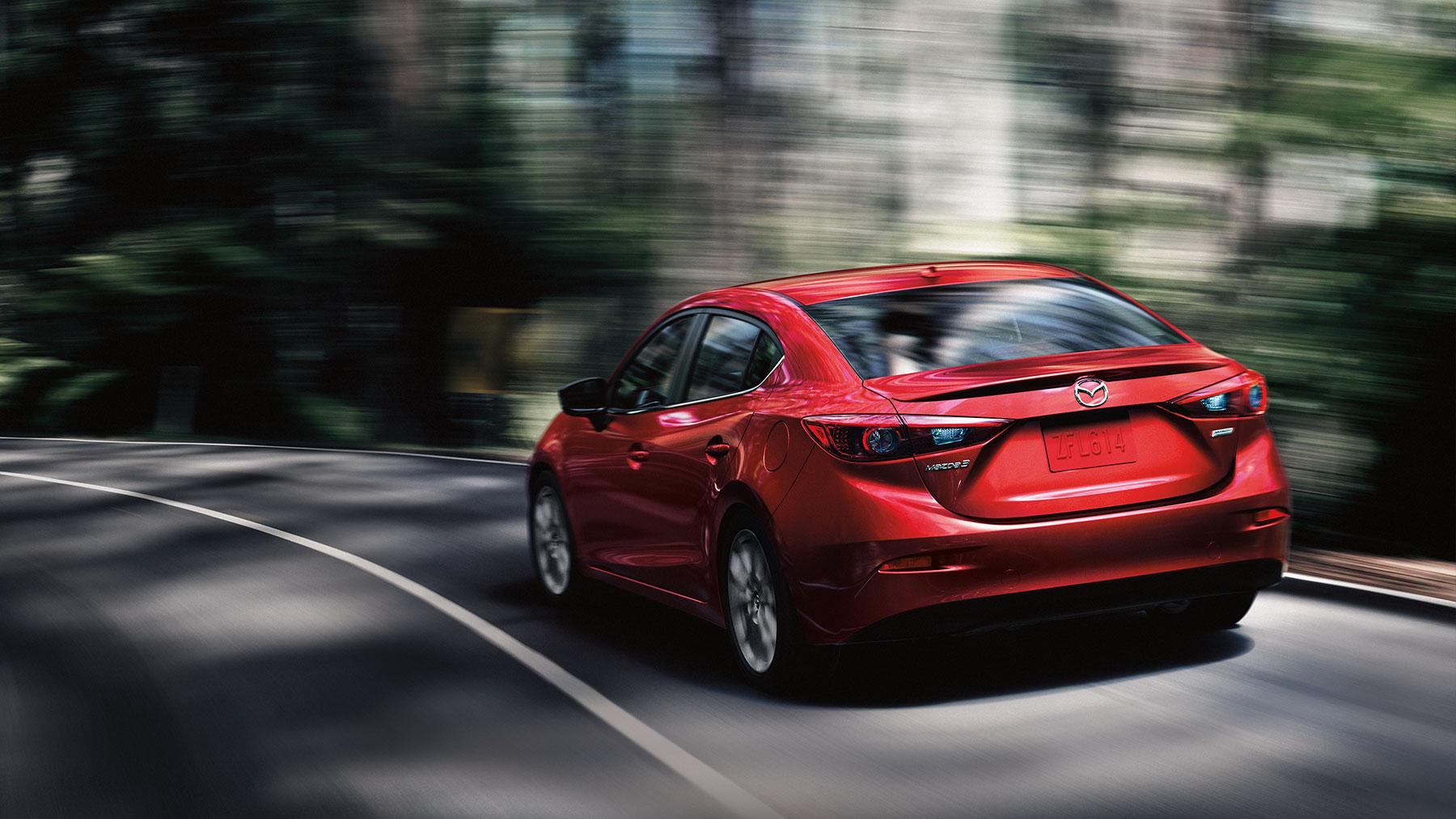 2019 Mazda 3 red color rear back side view on highway in forest 4k