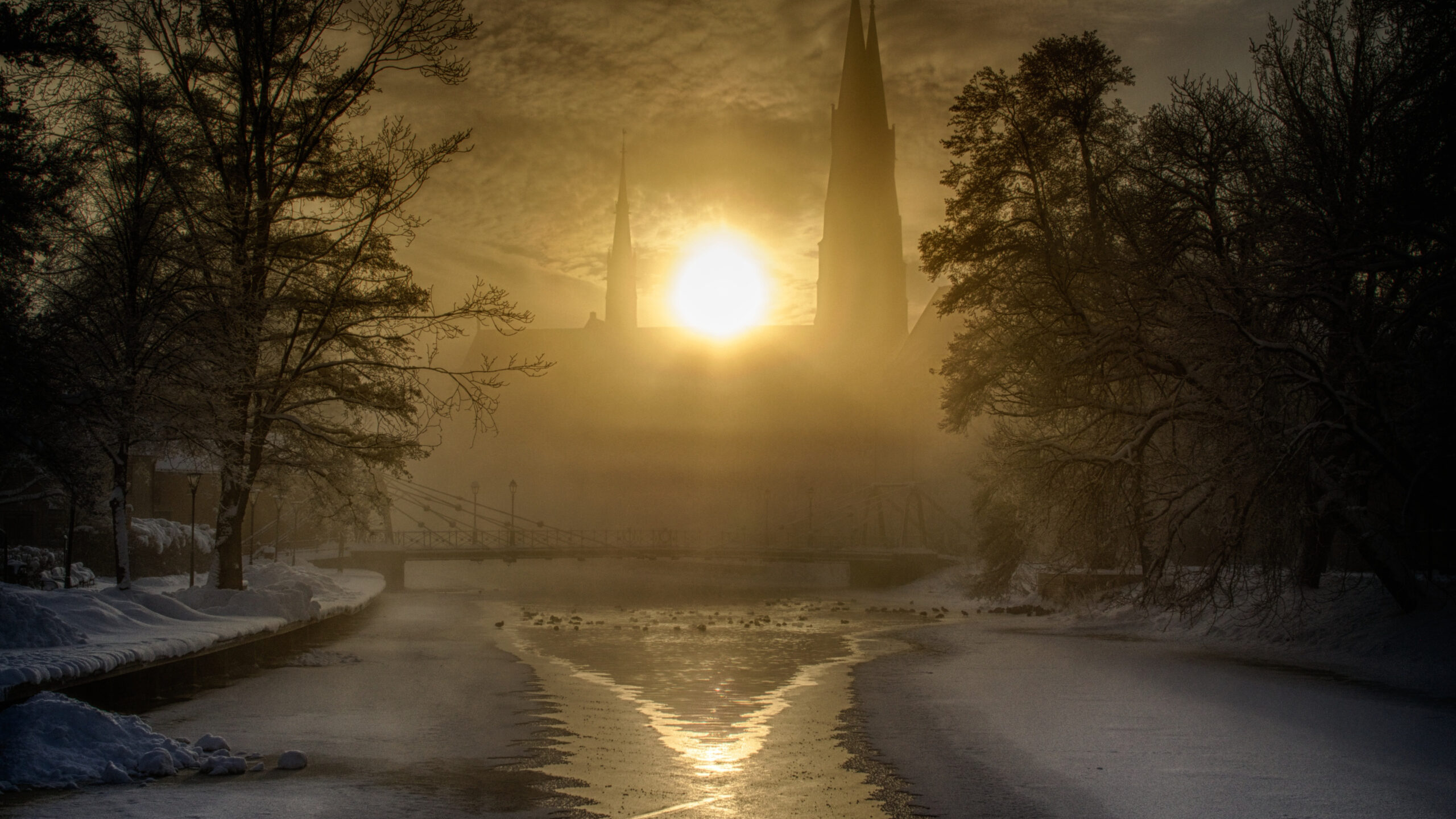 BOTPOST] ITAP of the sun rising behind Uppsala Cathedral in winter