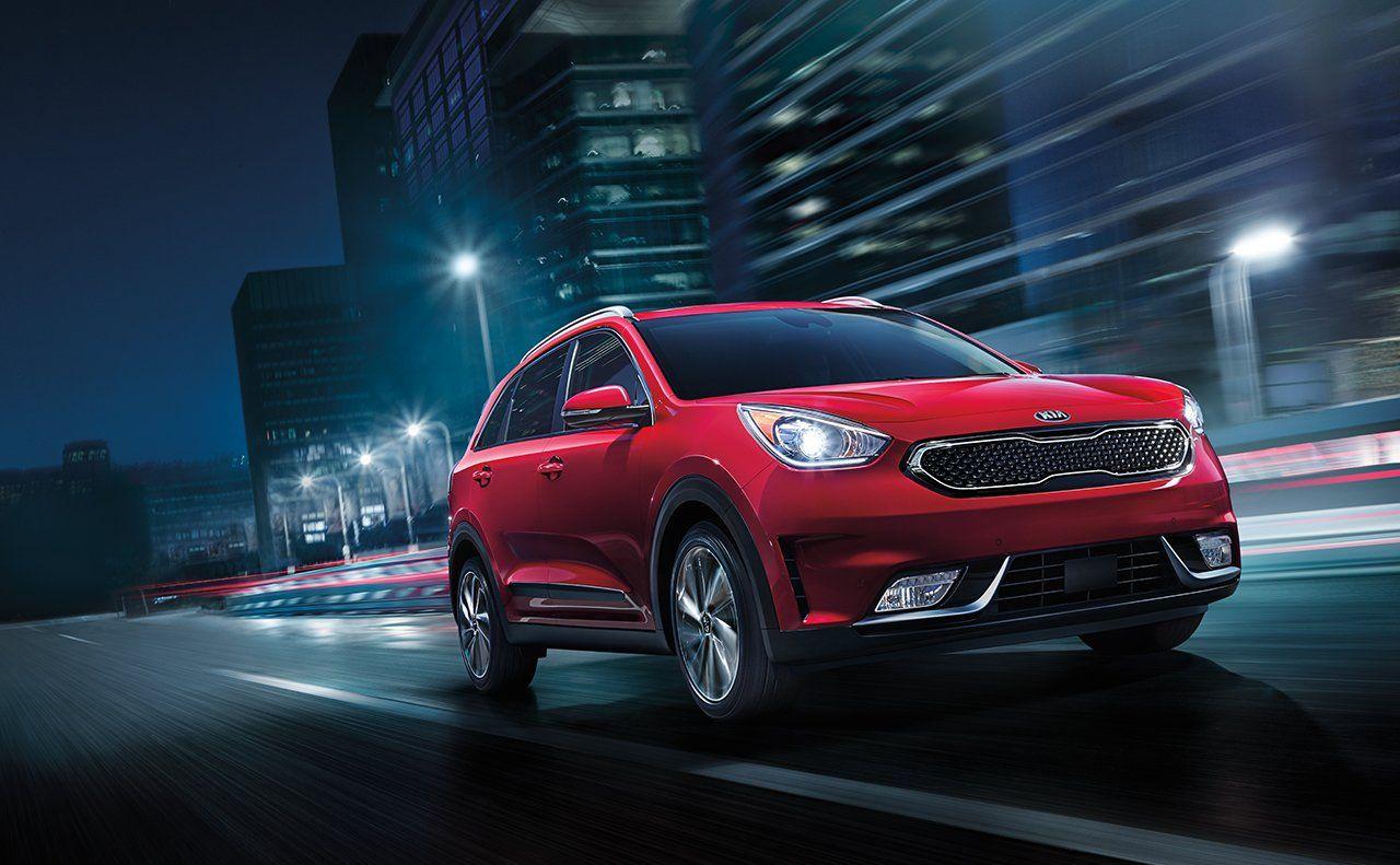 2019 Kia Niro EV red color night on road in city lights backgrounds