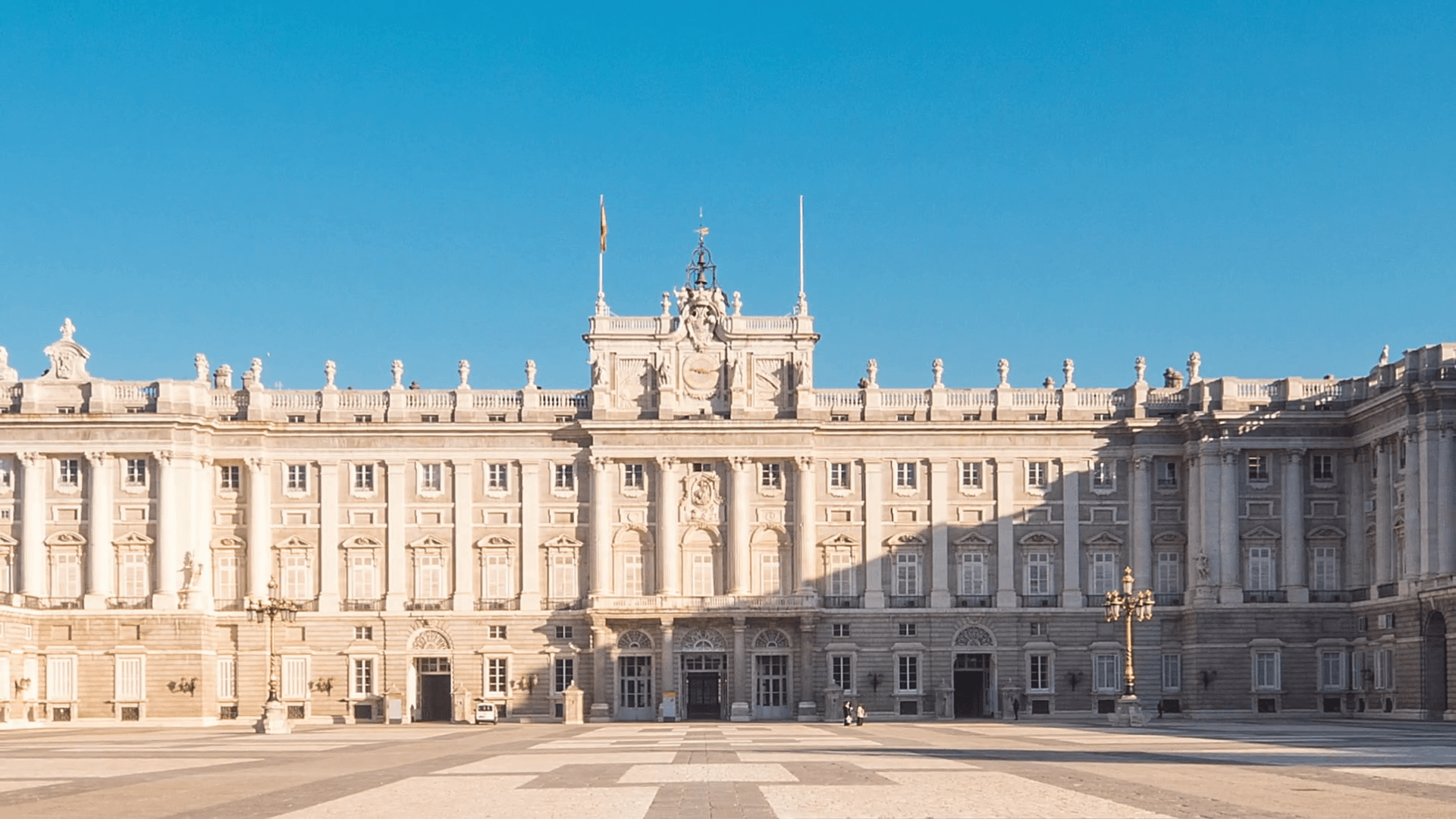 royal palace of madrid timelapse zoom out blue sky sun lighting the