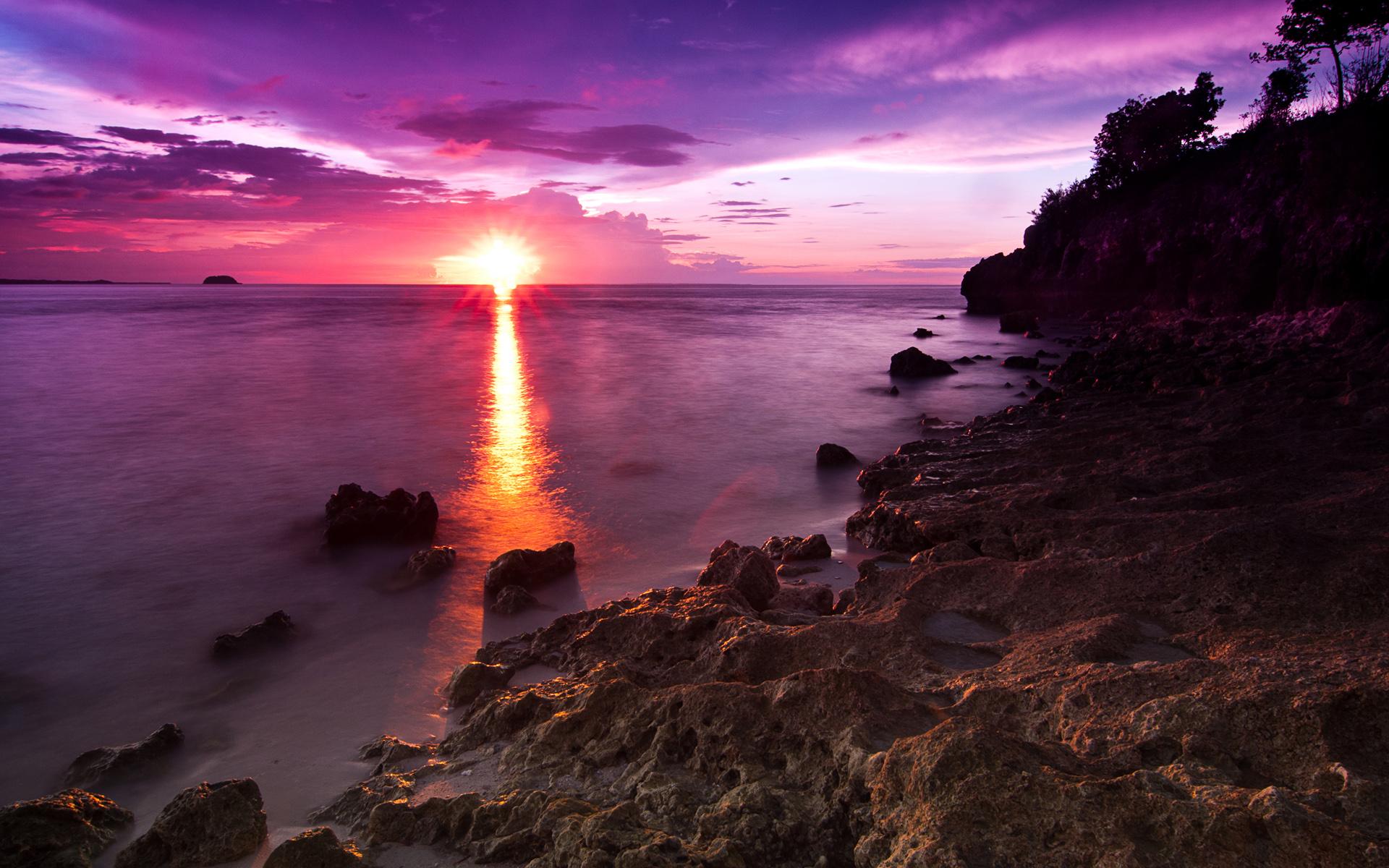 Rays of sunshine on rocky beach, Malapascua Island, Cebu Province