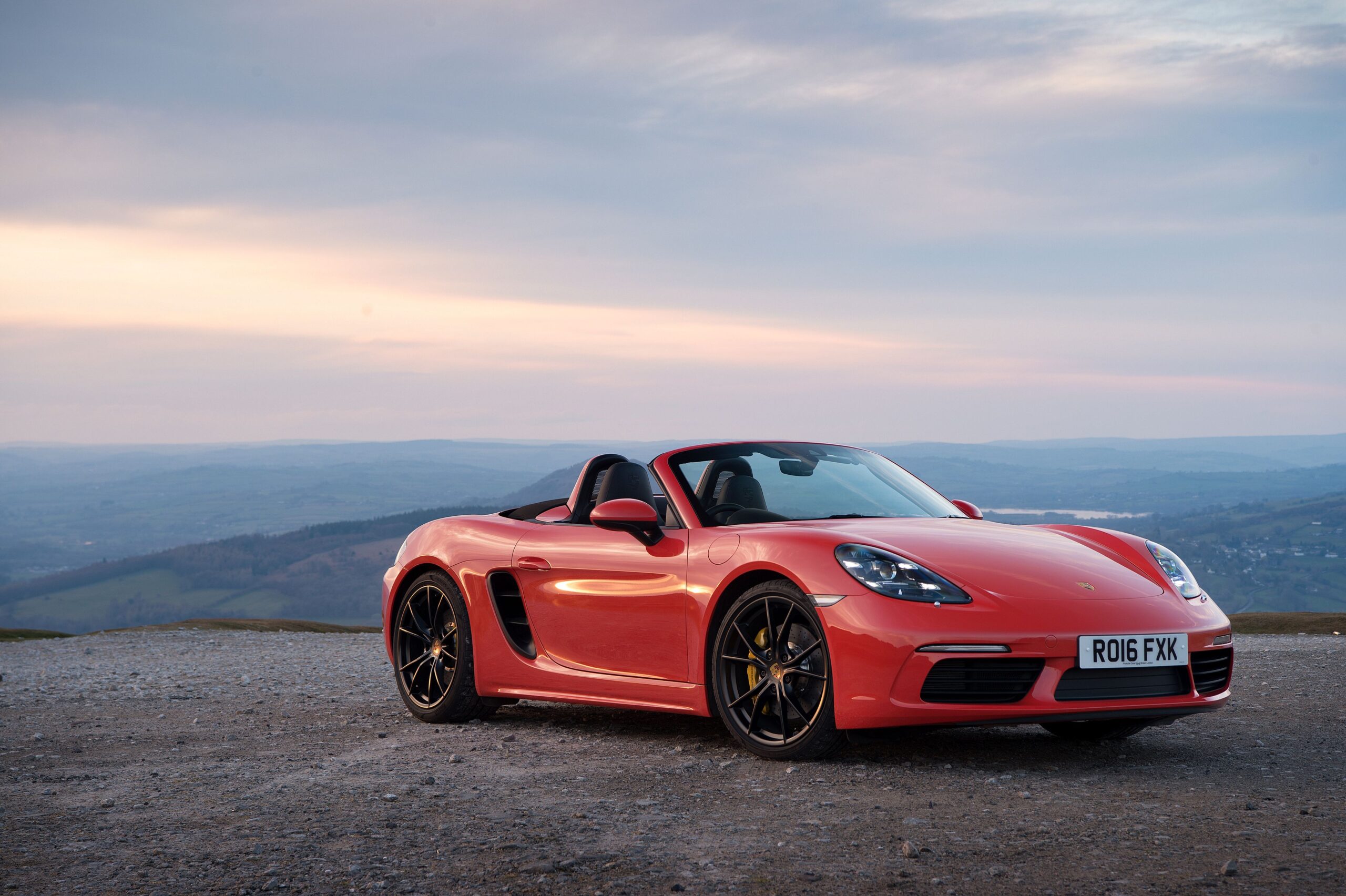 Red Car Convertible Porsche 718 Boxster on the backgrounds of the