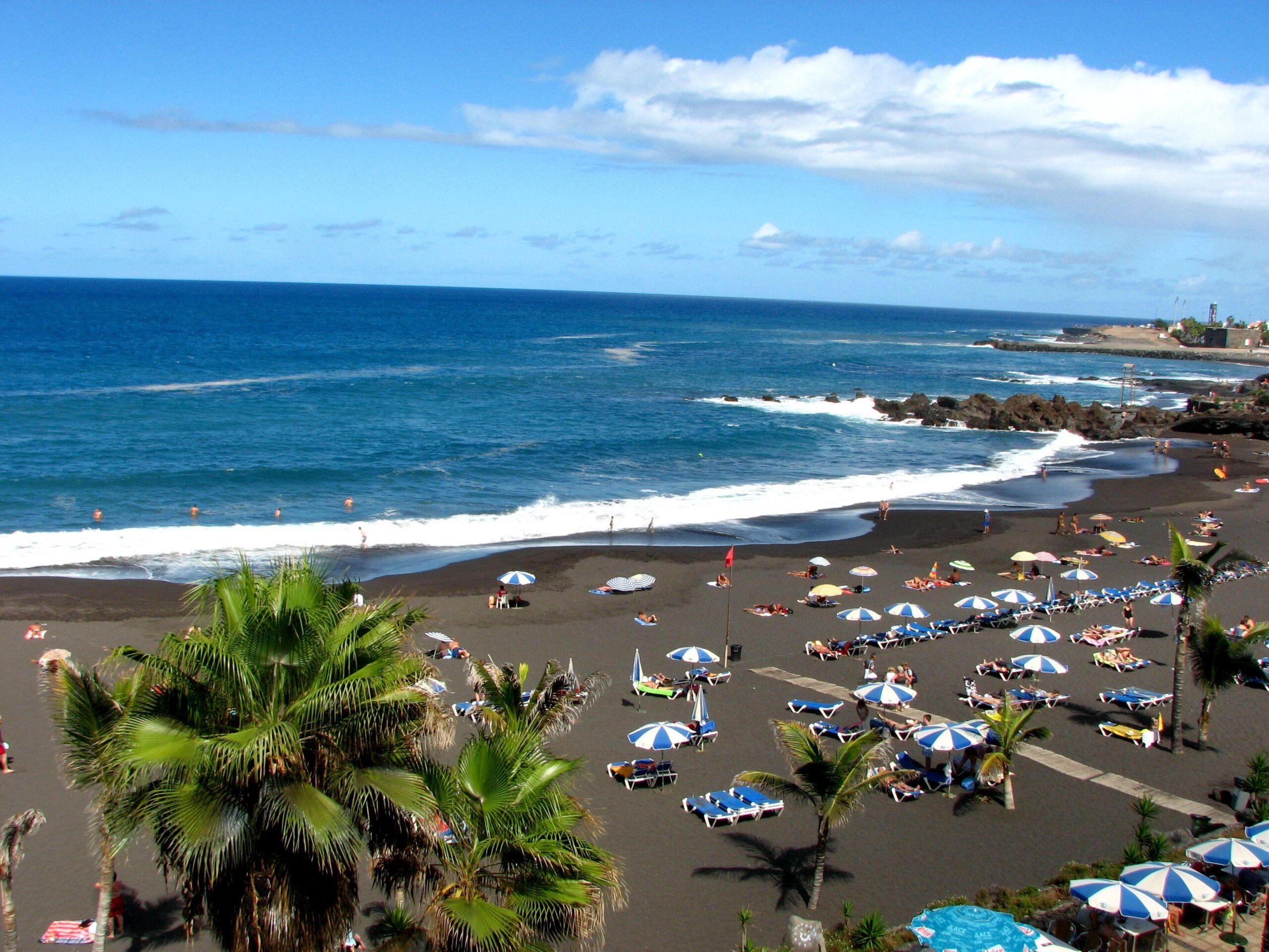 Tourism on the black beach in Tenerife wallpapers and image