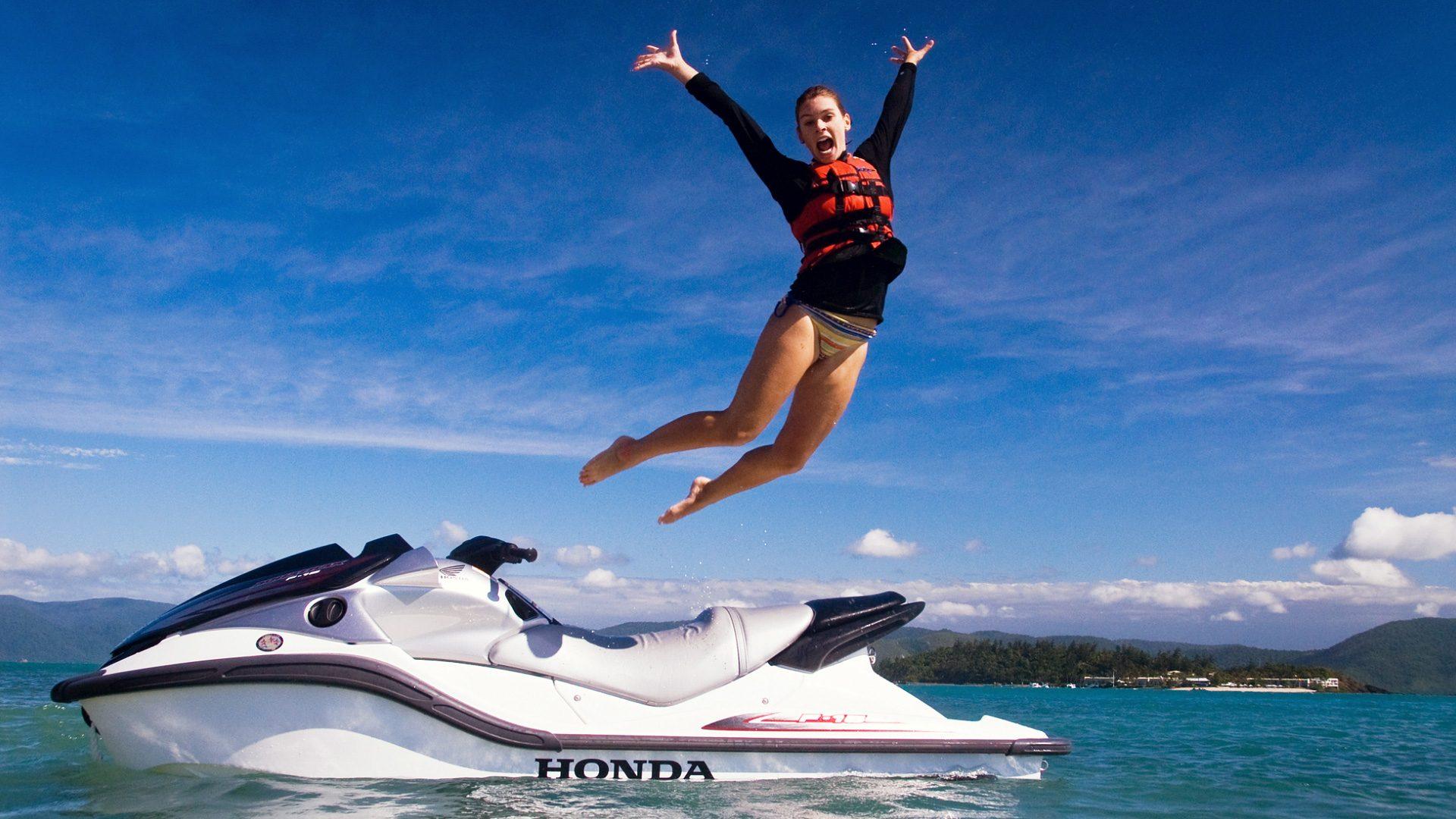 High Definition Wallpapers Of A Woman Jumping Out Of A Jetski